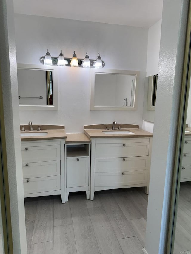 bathroom featuring vanity and hardwood / wood-style floors