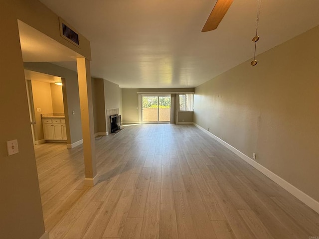 unfurnished living room with ceiling fan and light wood-type flooring