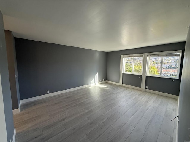 unfurnished room featuring light wood-type flooring