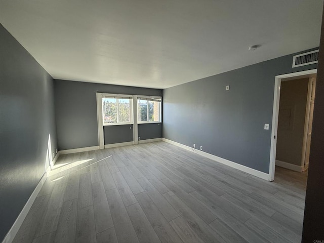 unfurnished room with light hardwood / wood-style floors