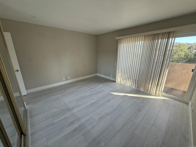 spare room featuring light wood-type flooring