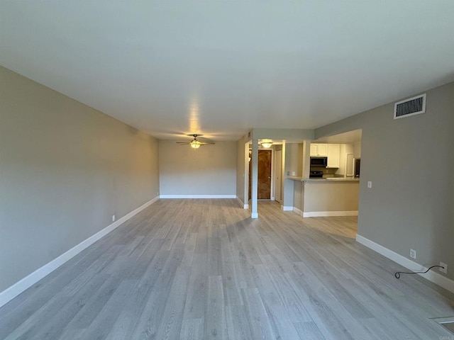 unfurnished living room with ceiling fan and light wood-type flooring