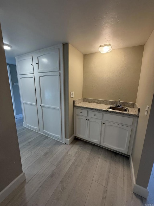 bathroom featuring wood-type flooring and sink