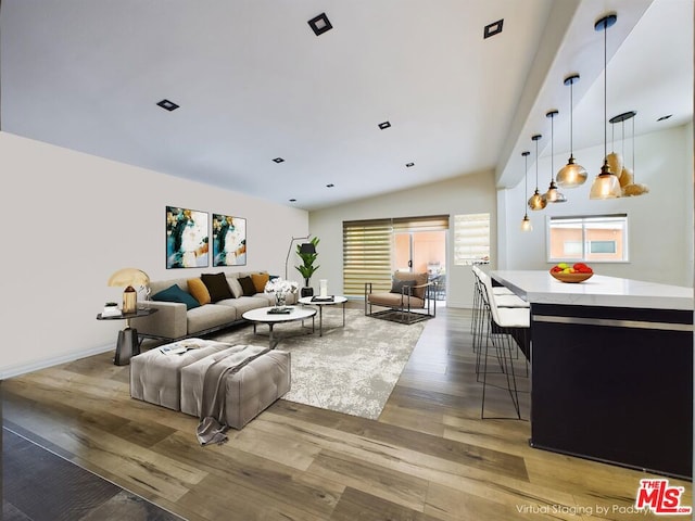 living room featuring lofted ceiling and hardwood / wood-style floors