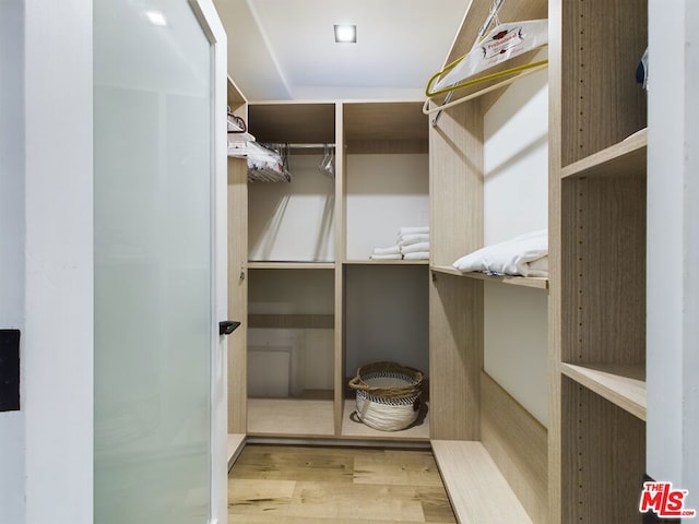 walk in closet featuring light hardwood / wood-style flooring