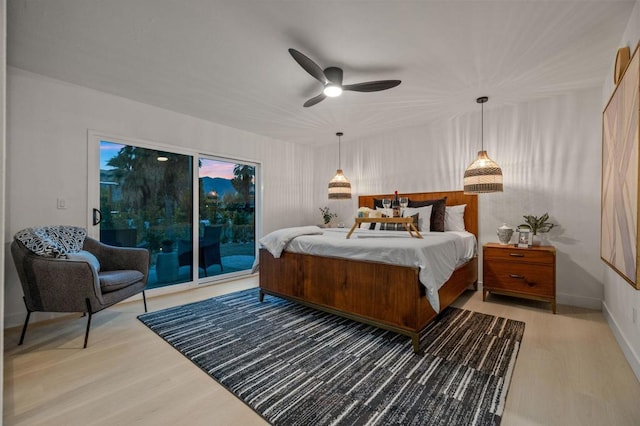 bedroom with ceiling fan, access to exterior, and wood-type flooring