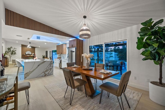 dining area with light hardwood / wood-style flooring and a chandelier