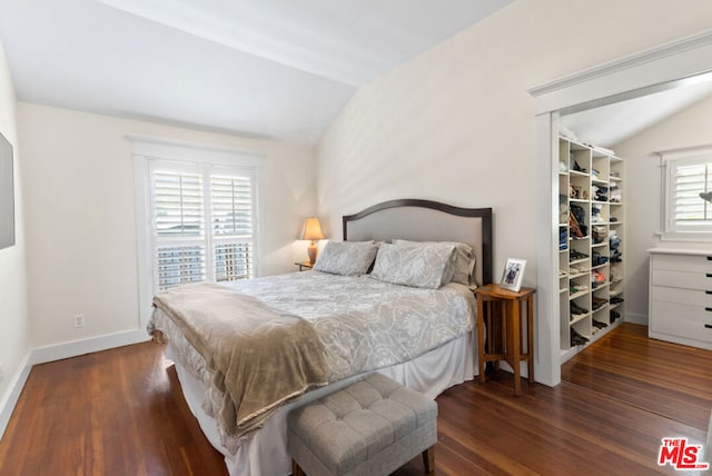 bedroom featuring dark hardwood / wood-style floors and lofted ceiling