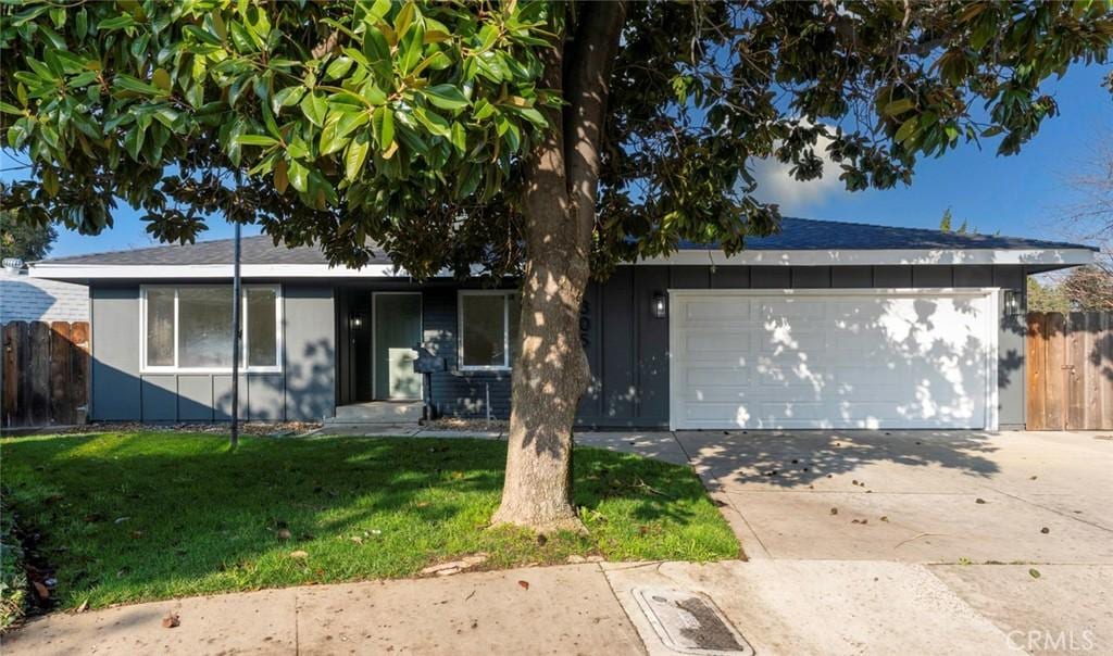 ranch-style home with a front yard and a garage