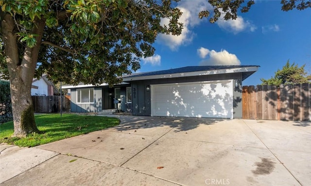 ranch-style house with a front yard and a garage