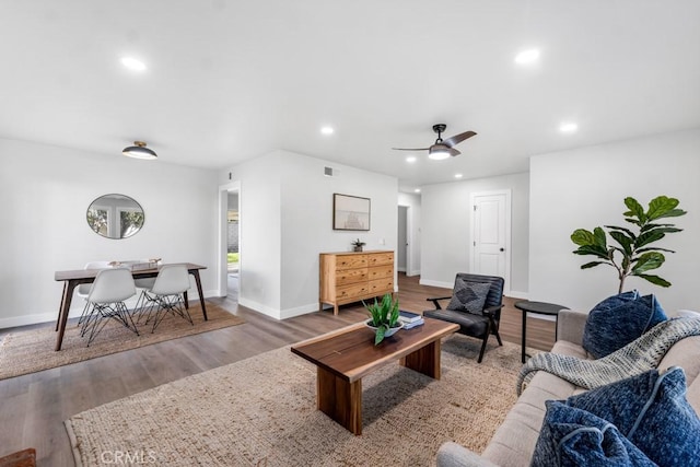 living room featuring ceiling fan and hardwood / wood-style flooring