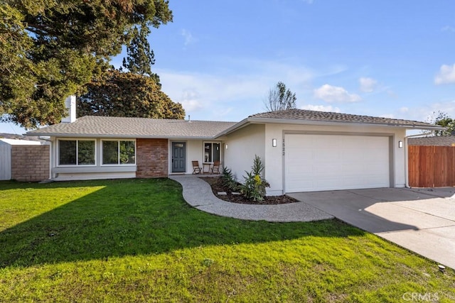 ranch-style house with a garage and a front yard