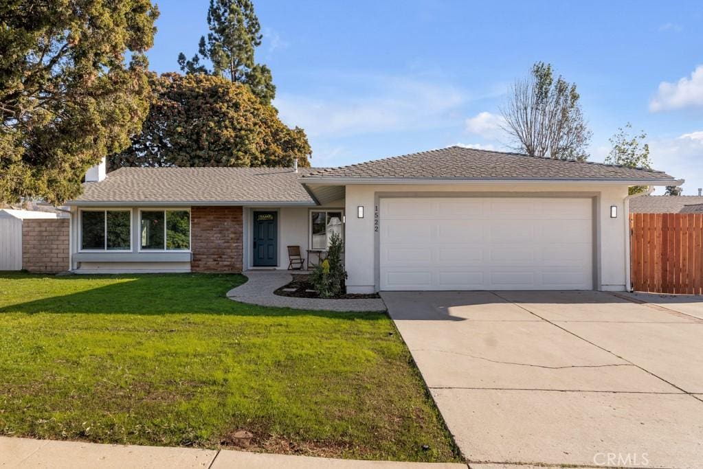 ranch-style home with a front yard and a garage