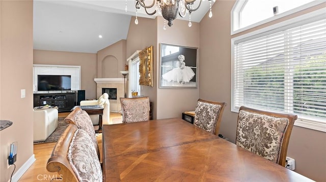 dining area featuring vaulted ceiling and a chandelier