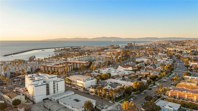 aerial view at dusk featuring a water view