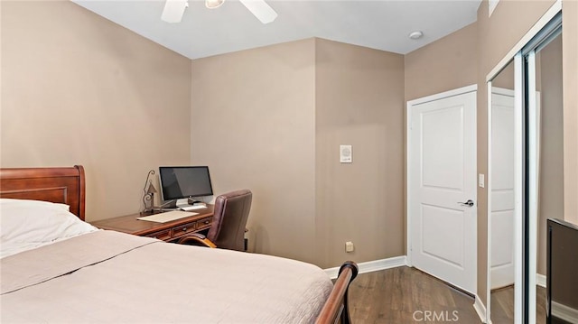 bedroom with ceiling fan and hardwood / wood-style flooring