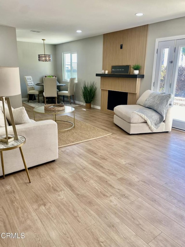 living room featuring plenty of natural light and light wood-type flooring