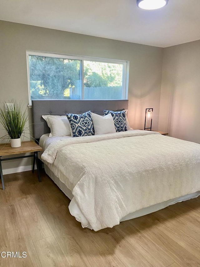 bedroom with hardwood / wood-style flooring