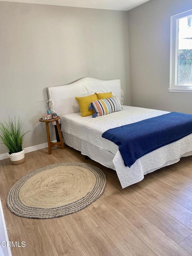 bedroom with hardwood / wood-style floors