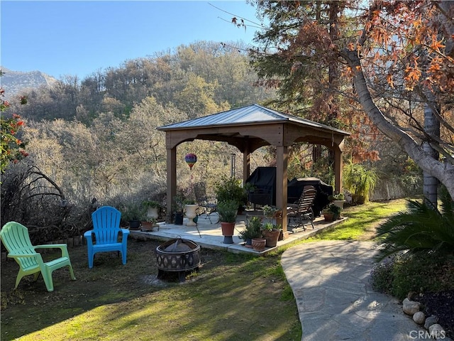 view of yard with a patio area, a gazebo, and an outdoor fire pit