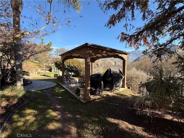 view of yard with a mountain view and a gazebo