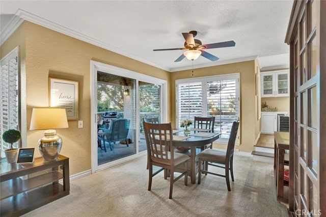 27704 Campanet Unit 31, Mission Viejo, CA 92692 - dining room with ceiling fan, light carpet, baseboards, and crown molding