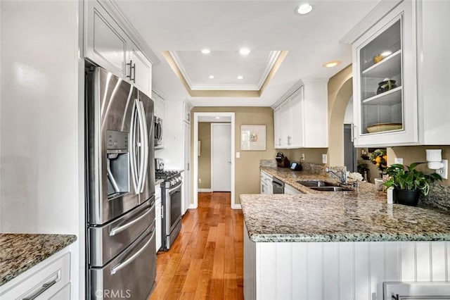 27704 Campanet Unit 31, Mission Viejo, CA 92692 - kitchen with stainless steel appliances, a sink, a tray ceiling, white cabinets, and recessed lighting