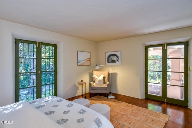 bedroom with dark hardwood / wood-style flooring and french doors