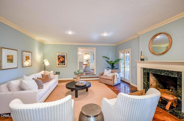 living room with a high end fireplace and ornamental molding