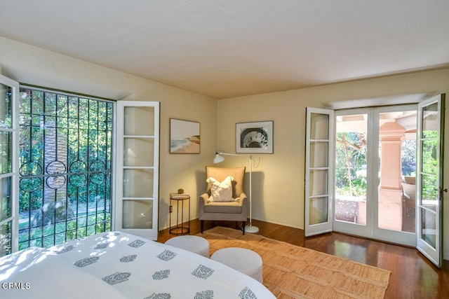 bedroom featuring dark hardwood / wood-style floors, access to exterior, and french doors