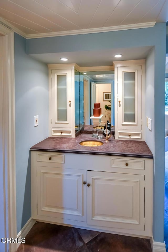 bathroom featuring crown molding and vanity