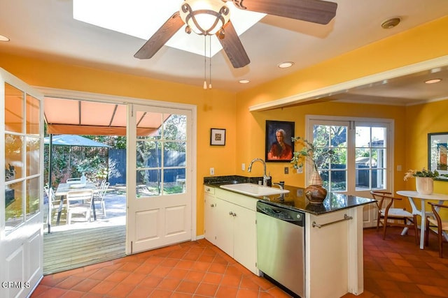 kitchen with plenty of natural light, dishwasher, sink, and white cabinets