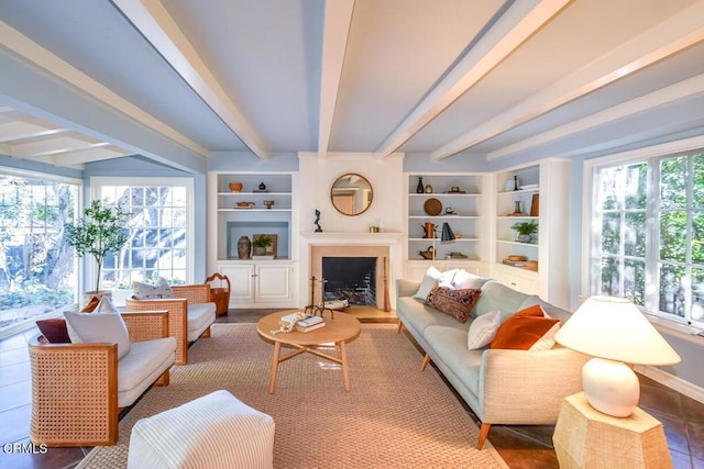 living room featuring beam ceiling and built in features