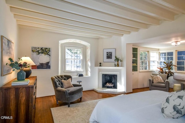 bedroom featuring beam ceiling and hardwood / wood-style floors