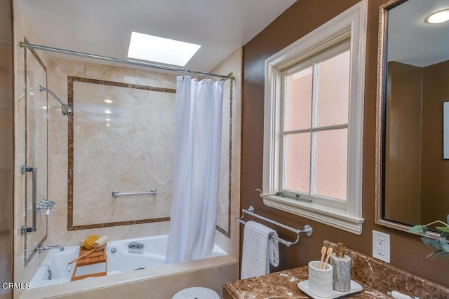 bathroom with shower / tub combo with curtain, vanity, a skylight, and a wealth of natural light