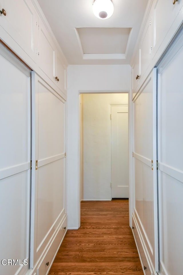 corridor with hardwood / wood-style floors