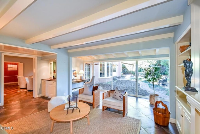 tiled living room featuring beamed ceiling