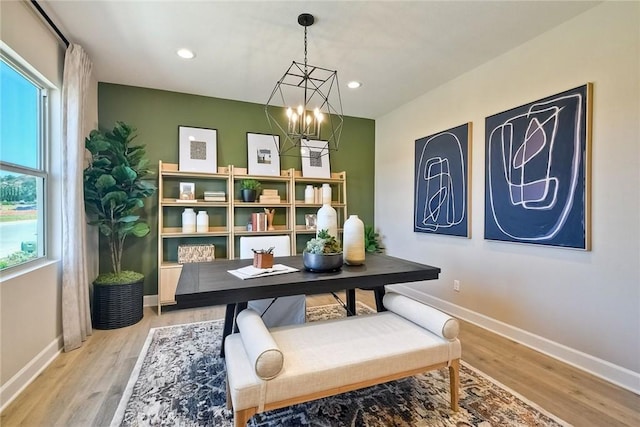 dining space with a chandelier and light hardwood / wood-style floors