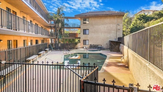 view of pool featuring a patio area