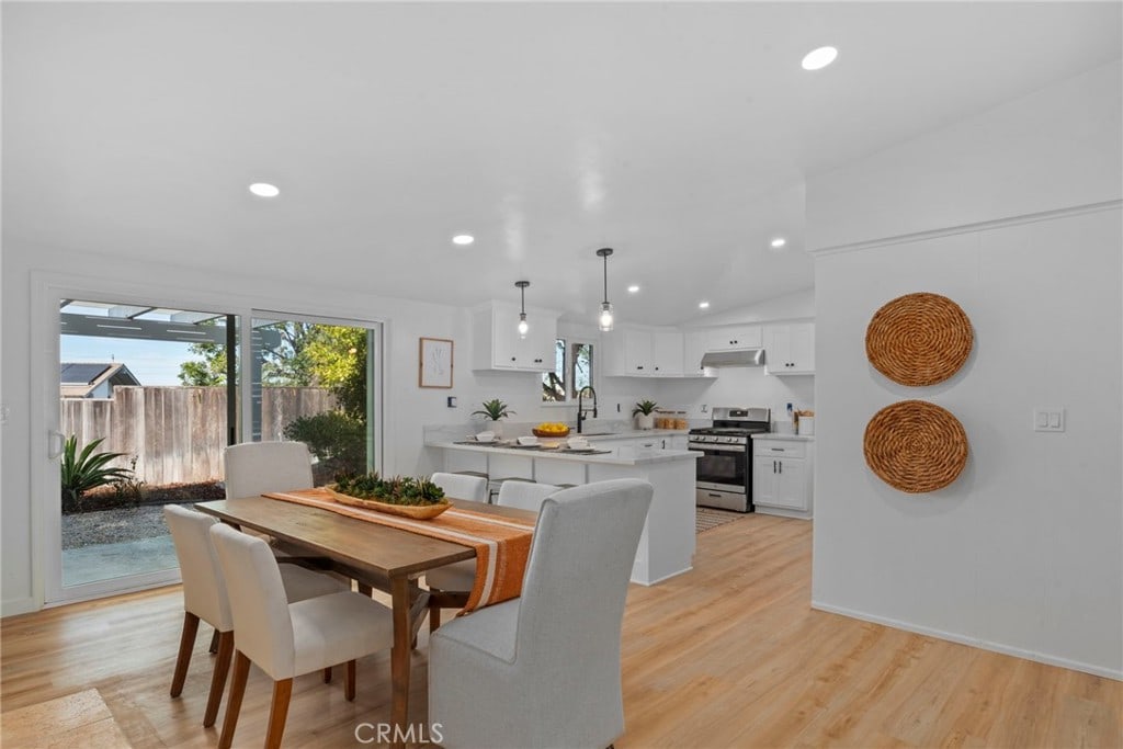 dining room featuring light wood-type flooring and sink