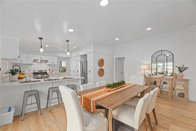 dining space featuring light wood-type flooring