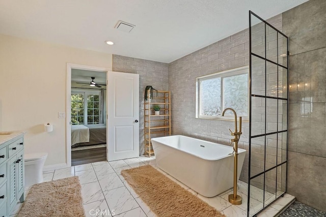 full bathroom featuring ceiling fan, toilet, vanity, and independent shower and bath