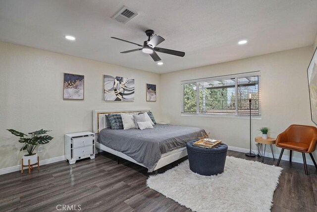 bedroom with ceiling fan and dark hardwood / wood-style floors