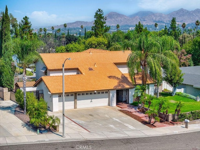 view of front of home with a garage and a mountain view