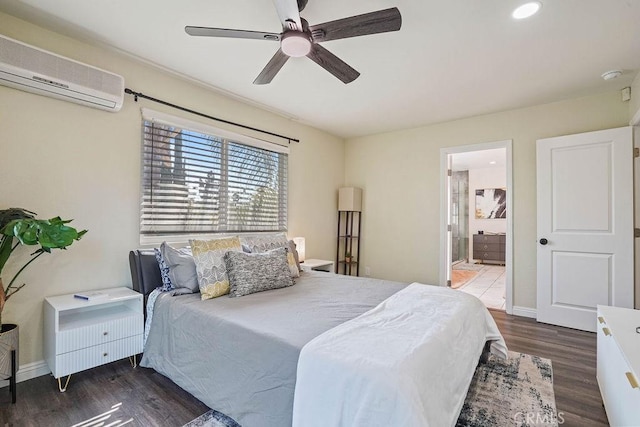 bedroom featuring ceiling fan, ensuite bathroom, a wall mounted AC, and dark hardwood / wood-style flooring