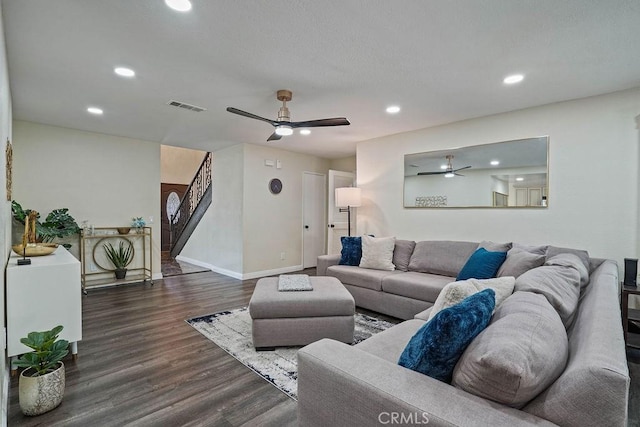 living room with dark wood-type flooring and ceiling fan