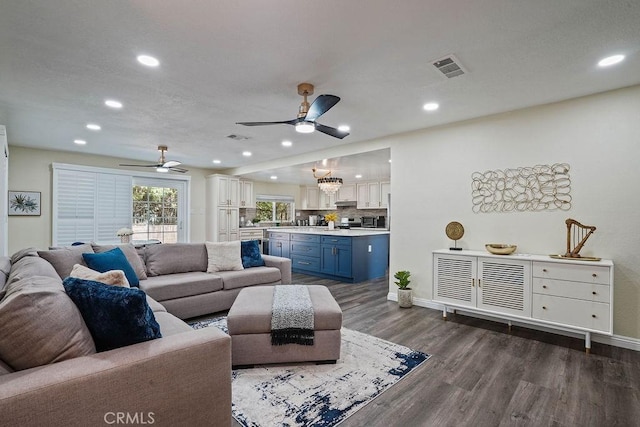 living room with ceiling fan and dark hardwood / wood-style floors