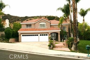 mediterranean / spanish house featuring a garage