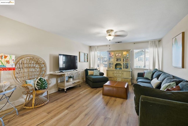 living room with light wood-type flooring and ceiling fan