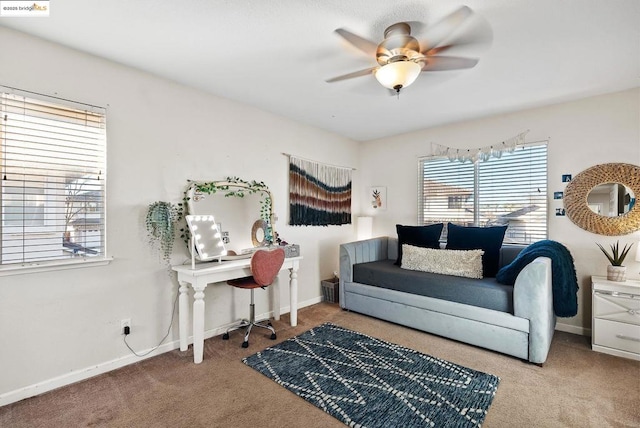 living area featuring ceiling fan and carpet